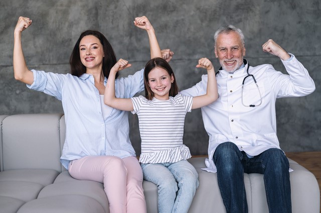 man, woman and little girl flexing muscles and smiling