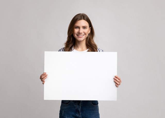 woman holding blank board